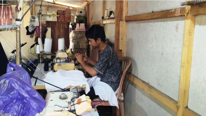 TAGIHAN PAJAK - Ismanto (32) buruh jahit harian lepas di Desa Coprayan, Kecamatan Buaran, Kabupaten Pekalongan sedang melakukan aktivitas hariannya, Jumat (8/8/2025). Dia bersama istrinya syok begitu memperoleh surat dari petugas mengenai pajak Rp2,8 miliar karena merasa tak pernah bertransaksi dengan nilai fantastis itu.