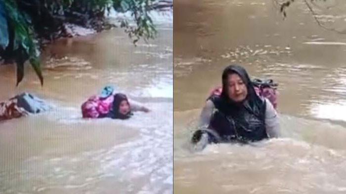 AKSI HEROIK BIDAN - Dona Lubis (46) saat mengarungi derasnya Sungai Batang Pasaman akibat jembatan yang terputus sepanjang 15 meter di Nagari Cubadak Barat, Kecamatan Dua Koto, Kabupaten Pasaman, untuk mengobati pasien, Jumat (1/8/2025).