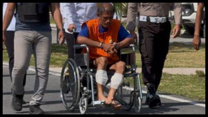 HUBUNGAN SEJENIS - Satreskrim Polres Siak menggiring Ihsan (44), pelaku pembunuhan Novrianto (39) di Tualang, menggunakan kursi roda saat hendak konferensi pers, Jumat (31/10/2025) di Mapolres Siak. Pengakuan mengejutkan Ihsan, pembunuh Novrianto, seusai pesta tuak di rumahnya pada Sabtu (25/10/2025), pernah hubungan sejenis dengan korban.