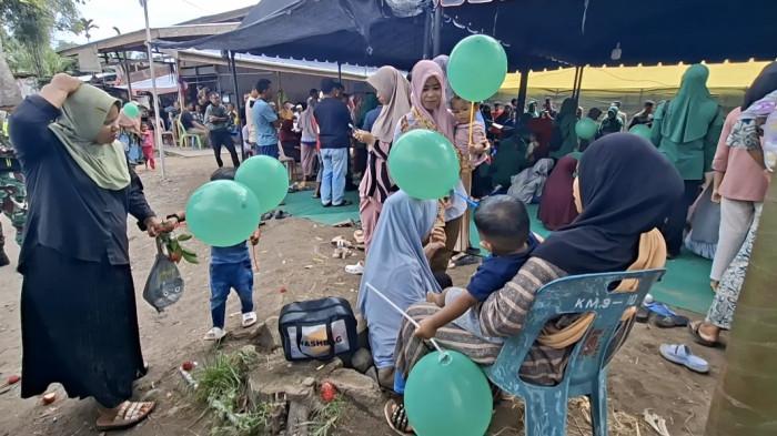 TRAUMA HEALING - Anak-anak warga Balee Panah, Juli Bireuen, Kamis (18/12/2025) ceria dengan kehadiran kaum ibu dari TP PKK bersama kaum ibu Persit Kartika Kodim 0111/Bireuen menyemangati mereka.