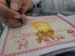 Emas-perhiasan-bentuk-kalung-di-toko-Tiara-dan-pekerja-sedang-menulis-surat-bukti-pembelian-emas.jpg