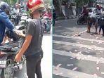 pengendara-berhenti-mendadak-mengutip-uang-pecahan-Rp-100-ribu.jpg