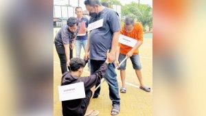 Pelaku-M-Saidi-baju-oranye-pegang-tombak-memeragakan-menombak-korban-Bunawai.jpg