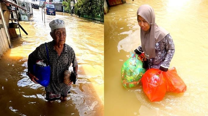 Warga-menerobos-banjir-DI-mARTAPURA.jpg
