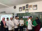 KEPALA-Kemenag-Tala-H-Saifudin-menyerahkan-paket-lebaran-dari-Baznas-kepada-pihak-yang-berhak.jpg