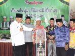 Ketua-LPTQ-Kapuas-KH-Muchtar-Ruslan-menyerahkan-piala-bergilir-MTQ-Selasa-04072023.jpg