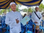 Rahmadi-baju-koko-dan-Naphani-memperlihatkan-sertifikat-tanah-miliknya.jpg