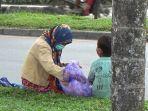 Seorang-ibu-dengan-membawa-anak-yang-masih-kecil-mengemis.jpg