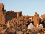 Tampak-warga-Afghanistan-di-depan-rumah-yang-rusak-akibat-gempa-bumi-di-desa-Sarbuland.jpg