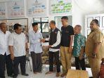 basznas-tanahlaut-menyerahkan-uang-bantuan-kepasa-tim-relawan-gabungan-tanahlaut.jpg