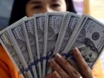 kasir-menunjukan-uang-dollar-amerika_20151222_192701.jpg