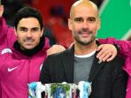 mikel-arteta-dan-pep-guardiola-merayakan-keberhasilan-manchester-city-menjuarai-piala-liga-inggris_20180518_060121.jpg