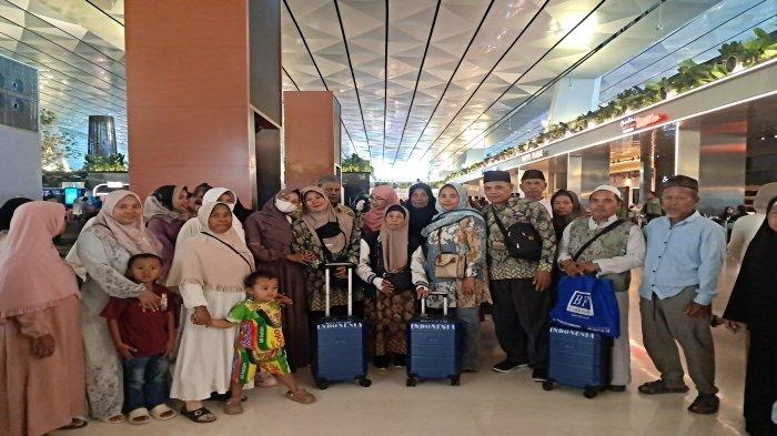 GAGAL BERANGKAT- Korban Salinah (tengah pakai kerudung coklat) bersama anaknya Sanimah (samping kanan Salinah), menantunya Sanusi (dua dari kiri Salinah), terduga pelaku Mustofa (pakai peci putih) dan keluarga besarnya saat di Bandara Soekarno Hatta, Kota Tangerang, Banten, Minggu (8/2/2026)