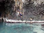 wisatawan-lompat-dari-atas-tebing-ke-kolam-air-laut-di-goa-kelelawar-yang-berada-di-pulau-shangiang.jpg