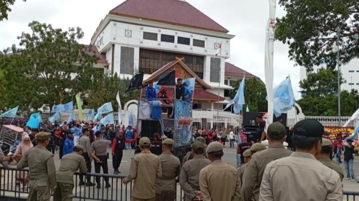UNJUK RASA - Buruh kota Batam yang tergabung dalam Serikat pekerja LEM SPSI Kepri saat melakukan unjukrasa di depan kantor Wali Kota Batam pada saat Hari Jadi Batam ke-196, di Batam Centre, Kamis (18/12/2025). Mereka menuntut upah pekerja