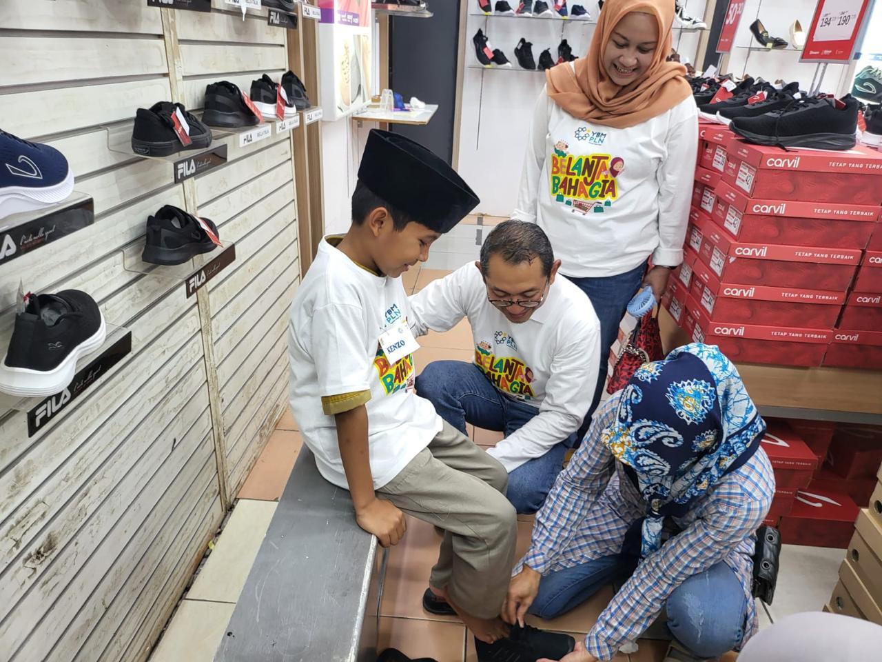 GM-PLN-Babel-membantu-anak-yatim-duafa-peserta-belanja-bahagia-memilihkan-sepatu.jpg