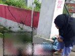 wanita-berkerudung-hitam-mendatangi-korban-pembacokan.jpg