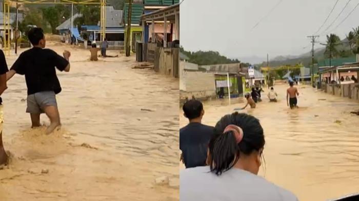 BANJIR -- Para warga Desa Hulawa menerjang banjir, tampak air selutut orang dewasa.