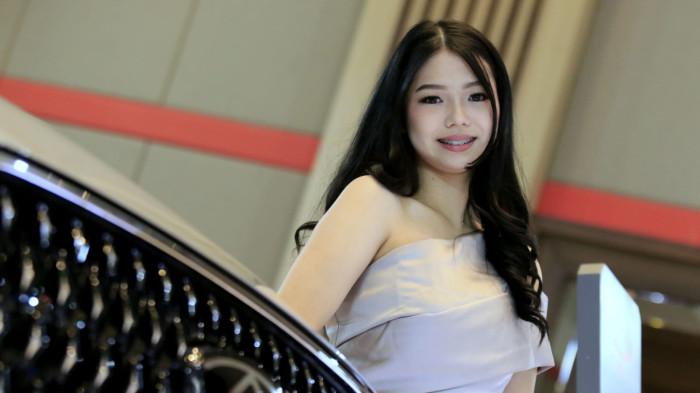Usher wanita berpose di samping kendaraan bermotor pada pameran otomotif Gaikindo Indonesia International Auto Show (GIIAS) Bandung 2025 di Sudirman Grand Ballroom, Kota Bandung, Jawa Barat, Kamis (2/10/2025).