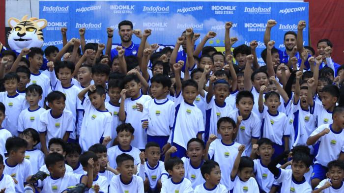 Anak-anak peserta coaching clinic berfoto bersama empat pemain Persib, Luciano Guaycochea, Uilliam Barros, Julio Cesar, dan Adam Alis pada Persibday Festival 2025 di Stadion Gelora Bandung Lautan Api (GBLA), Kota Bandung, Jawa Barat, Minggu (12/10/2025).