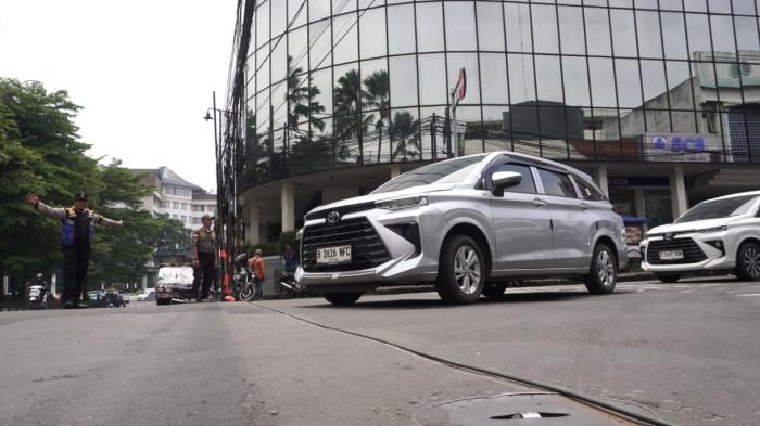 Petugas Bhabinkamtibmas dan Linmas Kelurahan Braga serta warga melakukan upaya pengamanan kabel fiber optik/internet yang menjuntai ke badan jalan, di Persimpangan Jalan Banceuy - Suniaraja, Kota Bandung, Jawa Barat, Rabu (29/10/2025).