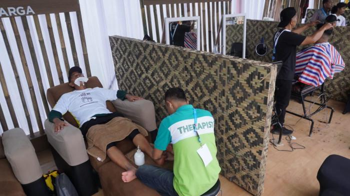 Pengunjung mendapat layanan pijat dan cukur gratis pada gelaran West Java Festival 2025, di Kiara Artha Park, Kota Bandung, Jawa Barat, Sabtu (8/11/2025).