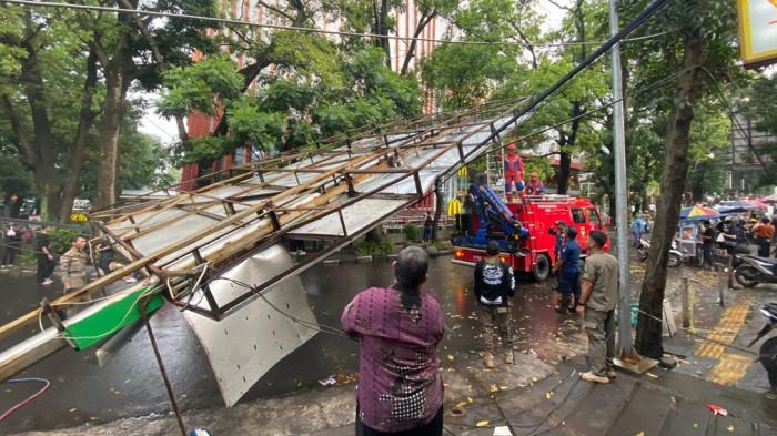 EVAKUASI REKLAME ROBOH - Petugas Damkar saat melakukan evakuasi reklame roboh di Jalan Purnawarman, Kota Bandung, Jumat (3/4/2026).