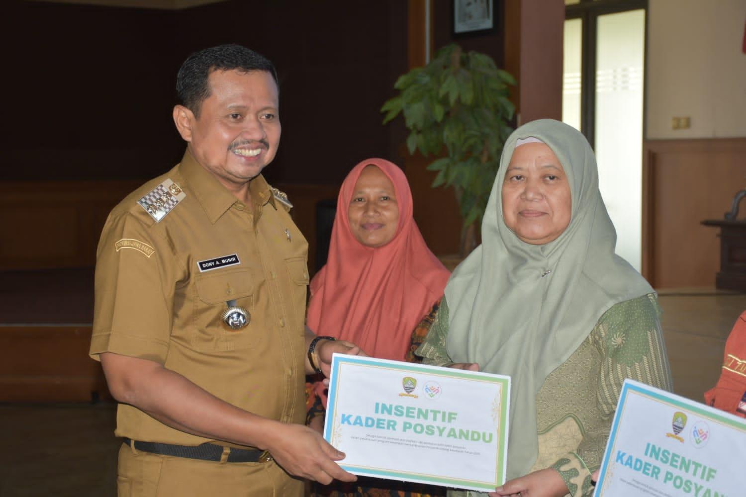 Bupati-Dony-saat-menyerahkan-insentif-kepada-Kader-Posyandu.jpg