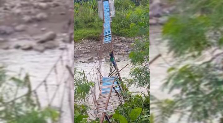 Seorang-warga-nekat-menyebarangi-jembatan-gantung-rusak-di-Sumedang.jpg