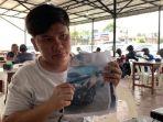 Syahrizal-menunjukkan-foto-mobilnya-yang-hilang-Jumat-332023.jpg