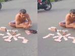 jabar/aksi-pria-menumpuk-uang-Rp350-juta-di-tengah-jalan.jpg