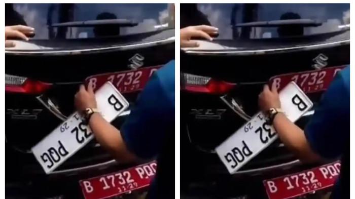 GANTI PELAT NOMOR - Polisi menegur mobil dinas DKI Jakarta yang mengganti pelat merah menjadi pelat putih saat melintas di jalur. Kepala BPAD DKI beri respons.