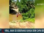 bocah-sebrangi-sungai-sambil-bergelantungan.jpg
