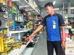 andi-spv-toko-memperlihatkan-rak-barang-yang-digasak-pencuri.jpg
