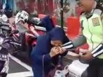 ibu-ibu-gigit-polisi_20180223_103536.jpg