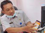 kabid-pengelolaan-dan-administrasi-kependudukan-samsir-saat-menunjukkan-aplikasi-sipuja.jpg