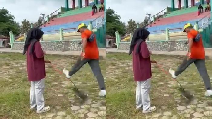KUCING DITENDANG - Tangkapan layar seorang pria bertopi tendang kucing di Lapangan Kridosono, Kabupaten Blora.(Dok. Tangkapan Layar)