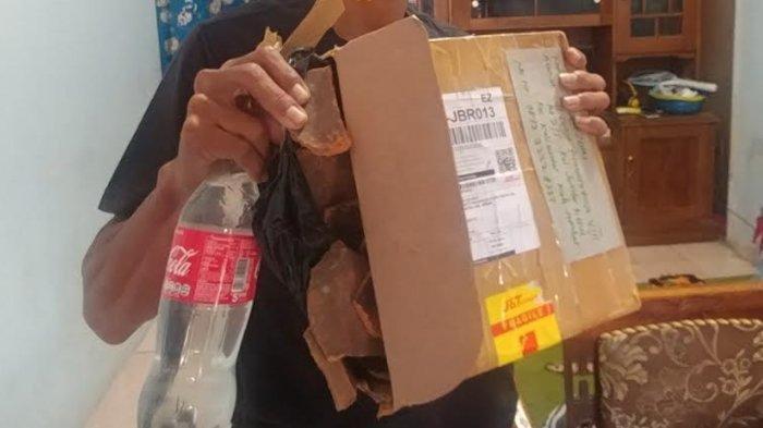 Yusuf menunjukkan paketan berisi pecahan genteng yang dia terima