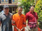 Polisi-menggiring-tersangka-Ketut-Danu-Indrawan.jpg