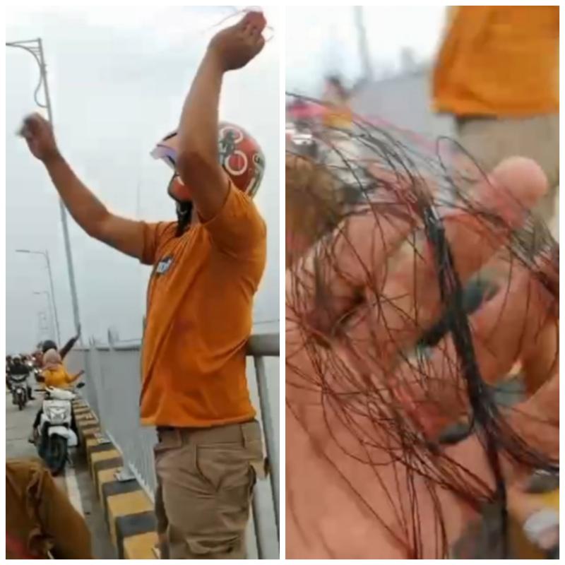 Pemotor Terpaksa Menepi Gulung Senar Layangan Meresahkan di Jalur Sepeda Motor Jembatan Suramadu