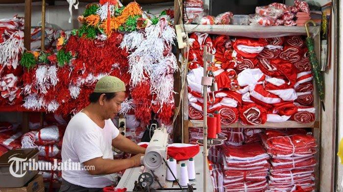 Nurcholis Arifin, menyelesaikan pembuatan bendera Merah Putih di Kampung Bendera, Darmokali, Surabaya, Senin (29/7). Hasil produksi konveksi bendera dari Kampung Darmokali RT 10 RW 4 Kelurahan Darmokali, Kecamaran Wonokromo, sudah diakui banyak daerah. Bahkan, produk Bendera Merah Putih di kampung ini sudah dikirim di berbagai wilayah di banyak daerah, termasuk Nusa Tenggara Timur, Ende, bahkan Papua.