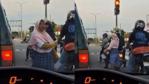 Aksi-seorang-perempuan-yang-diduga-sebagai-pengemis-memukul-kepala-pengendara-sepeda-motor.jpg