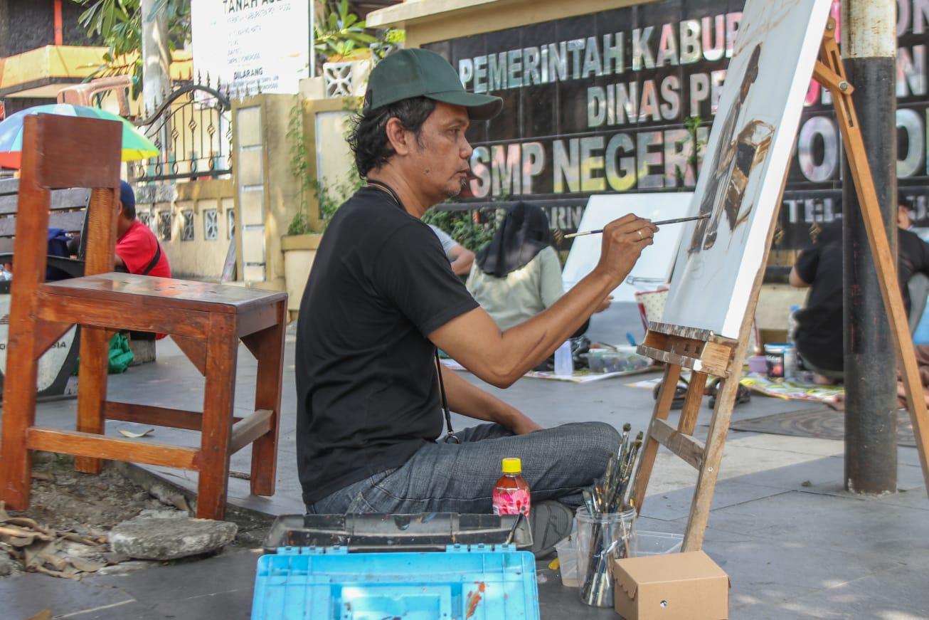 seniman-melukis-di-hos-cokroaminoto-ponorogo.jpg