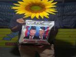 Ini-beras-bantuan-kemasan-5-kilogram-dalam-plastik-bergambar-Capres-Cawapres.jpg