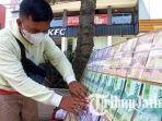 Jasa-penukaran-uang-baru-di-sekitar-Alun-alun-Kota-Malang-hukum-jual-uang-menurut-Buya-Yahya.jpg
