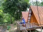 Pengunjung-menikmati-suasana-teduh-di-depan-tenda-kerucut-di-pinggiran-aliran-sungai-Teduh-Glamping.jpg