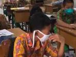 murid-SDN-81-Pekanbaru-Riau-memakai-masker-saat-mengikuti-ujian-kenaikan-kelas.jpg