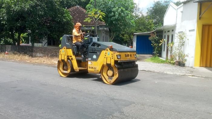 PERBAIKAN JALAN - Tim perbaikan jalan dari DPUPKP Kabupaten Sleman sedang menambal lubang jalan di ruas jalan Seyegan menuju arah Tempel, pada Senin (16/3/2026). Pemeliharaan jalan ini bagian dari persiapan pemerintah untuk memberikan kenyamanan bagi pengguna jalan pada arus mudik lebaran 1447 H