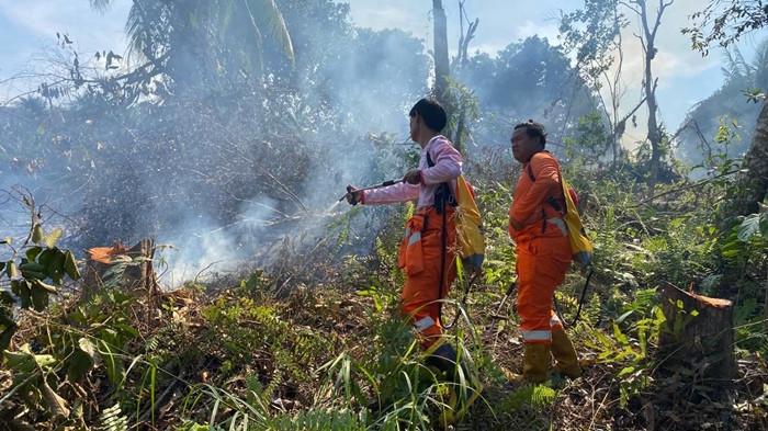 KARHUTLA NUNUKAN - Petugas gabungan dari BPBD Nunukan, MPA, dan kepolisian berjibaku memadamkan kebakaran hutan dan lahan di Jalan Anastasia Wijaya RT 03, Kelurahan Mansapa, Kecamatan Nunukan Selatan, Jumat (8/5/2026). Kebakaran yang menghanguskan sekitar 1 hektare lahan tersebut, berhasil dipadamkan pada pukul 16.00 WITA, meski petugas terkendala sumber air dan akses menuju lokasi. (TribunKaltara.com/Istimewa-Hasanuddin)