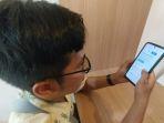 Salah-seorang-pendaftar-CPNS-2024-mengecek-website-SSCASN-srbf.jpg